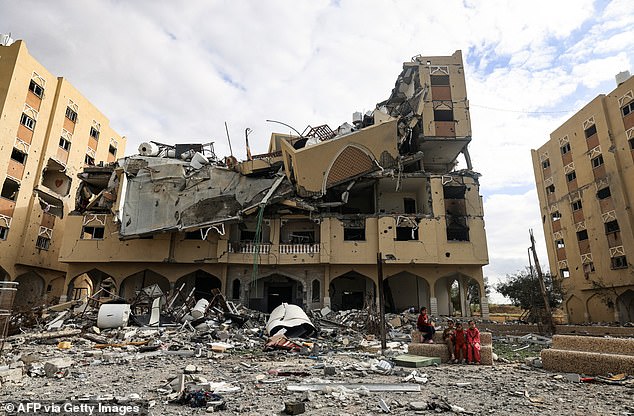 Palestinians inspect the destruction caused by Israeli attacks in Wadi Gaza, in the central Gaza Strip on November 28, 2023