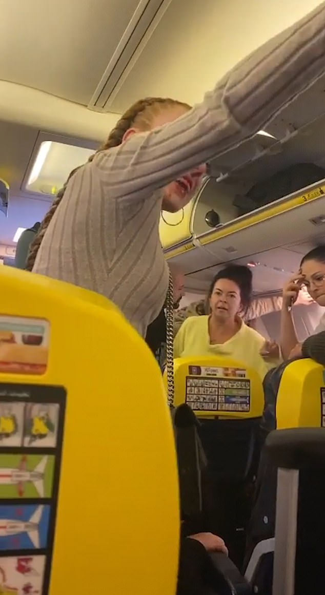 The scene of chaos during the Ryanair flight as the woman with the bloody nose gestures into the plane