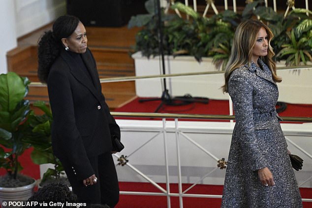 Melania Trump and Michelle Obama take their seats