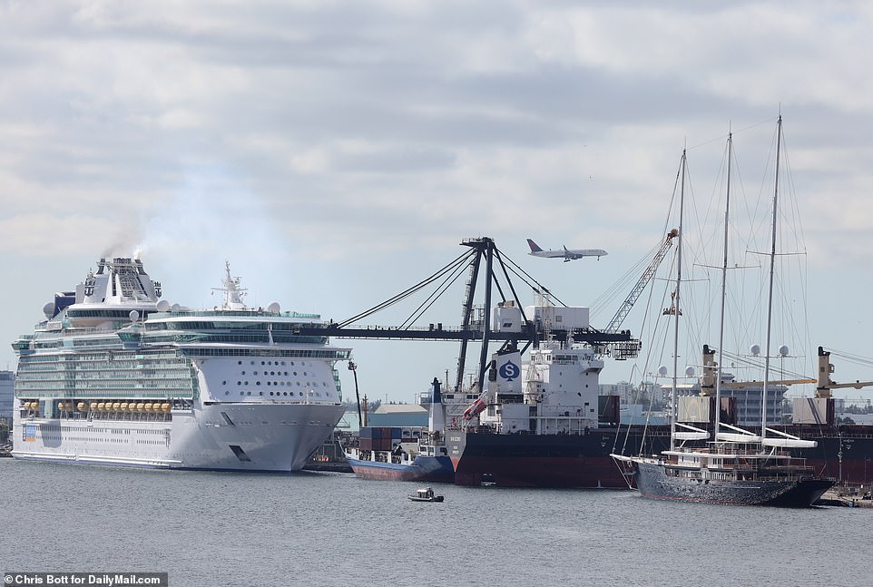 Exclusive images from DailyMail.com show the lavish three-masted schooner docked in Port Everglades, nestled between giant oil tankers and the enormous Liberty of the Seas cruise ship.
