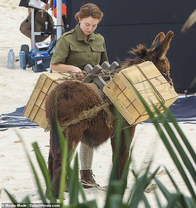 She also wore an olive-colored ensemble that consisted of a belted jacket and shorts