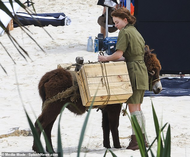 During the scenes, Sydney was seen securing two wooden boxes onto a donkey