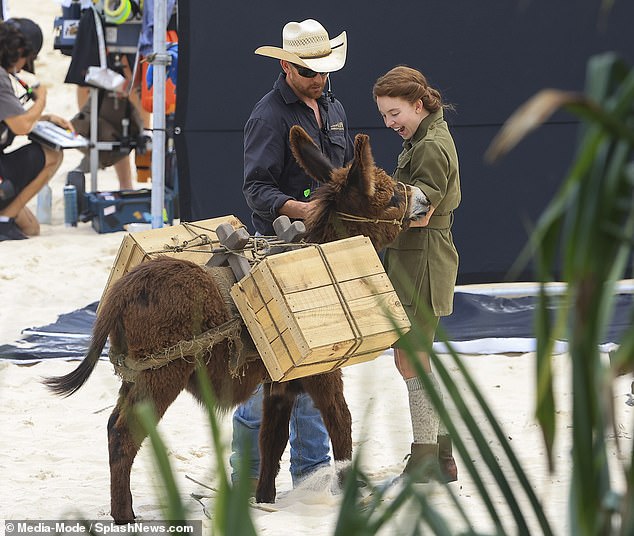 She smiled brightly as she met the donkey she would be filming a scene with