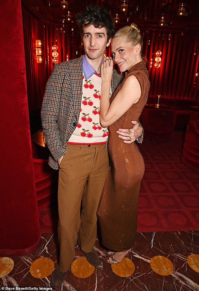 Poppy got cozy with Max Hurd, an art director and stylist, who wore a sweater covered in cherries and a plaid jacket