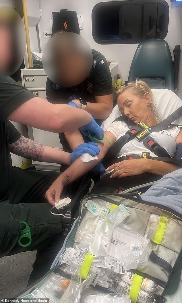 Ms Sword is treated by paramedics in the back of the ambulance after taking the 'lean medicine'