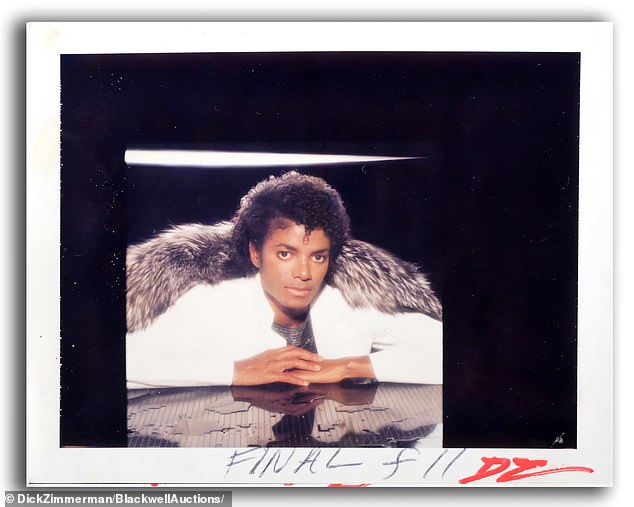 Michael Jackson poses in white.  The photos are sold under copyright, which means the winning bidder can reproduce them commercially