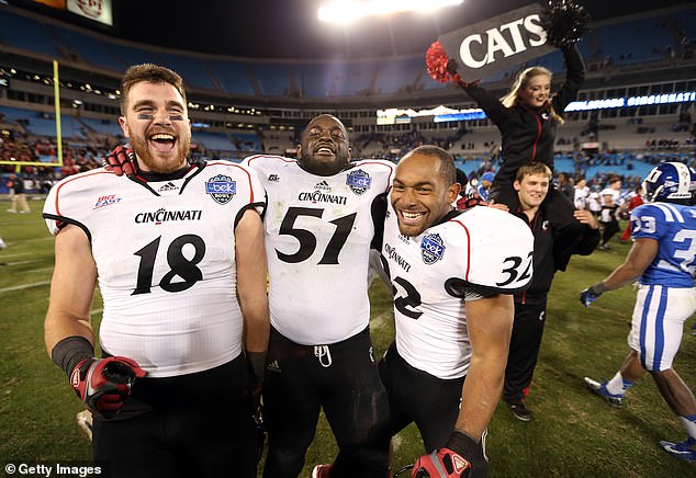 UC teammates George Winn #32, Travis Kelce #18 and Greg Blair #51 celebrate a victory in 2012