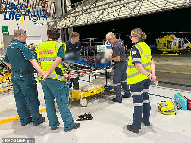 He suffered 'multiple injuries' when the gray Mazda 3 he was driving rolled over at the corner of Lamington Tce and Panorama Dr in Nambour at around 6.30pm (paramedics are pictured assisting the toddler)