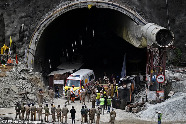 Dozens of emergency vehicles were photographed around the site of the tunnel collapse today as onlookers eagerly awaited news of the rescue mission