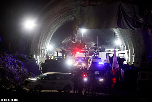 Ambulances enter a tunnel where rescue operations are underway to rescue trapped workers after the tunnel collapsed, in Uttarkashi, November 28, 2023