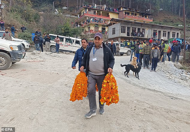 Flower garlands are taken to welcome the first people rescued from a tunnel on the Brahmakal Yamunotri National Highway in Uttarkashi, India, November 28, 2023