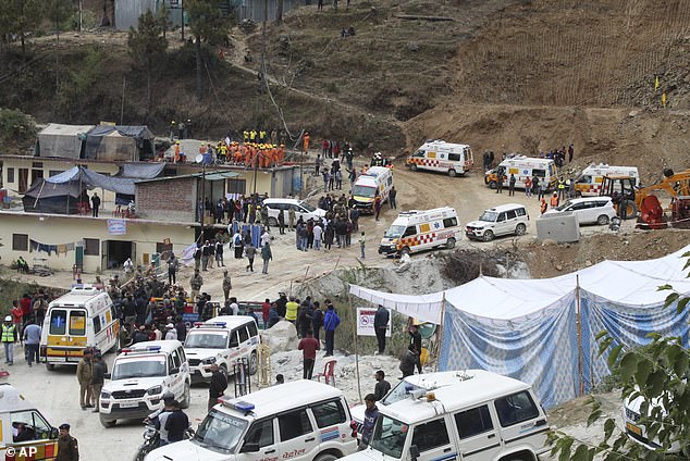 Ambulances wait to transport workers from the site of an under-construction road tunnel that collapsed in Silkyara in the northern Indian state of Uttarakhand, India, Tuesday, November 28, 2023