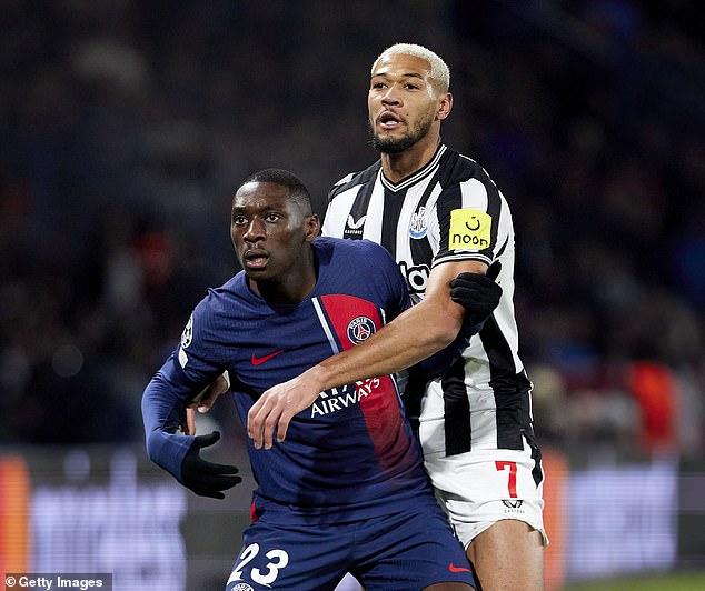 PSG's Randal Kolo Muani and Newcastle's Joelinton battle for the ball at the Parc des Princes