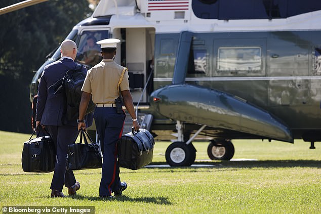 A military aide carries the 'nuclear football', which contains launch codes for nuclear weapons