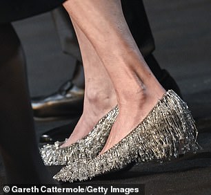 The actress opted for statement, bejeweled heels for her night out in London