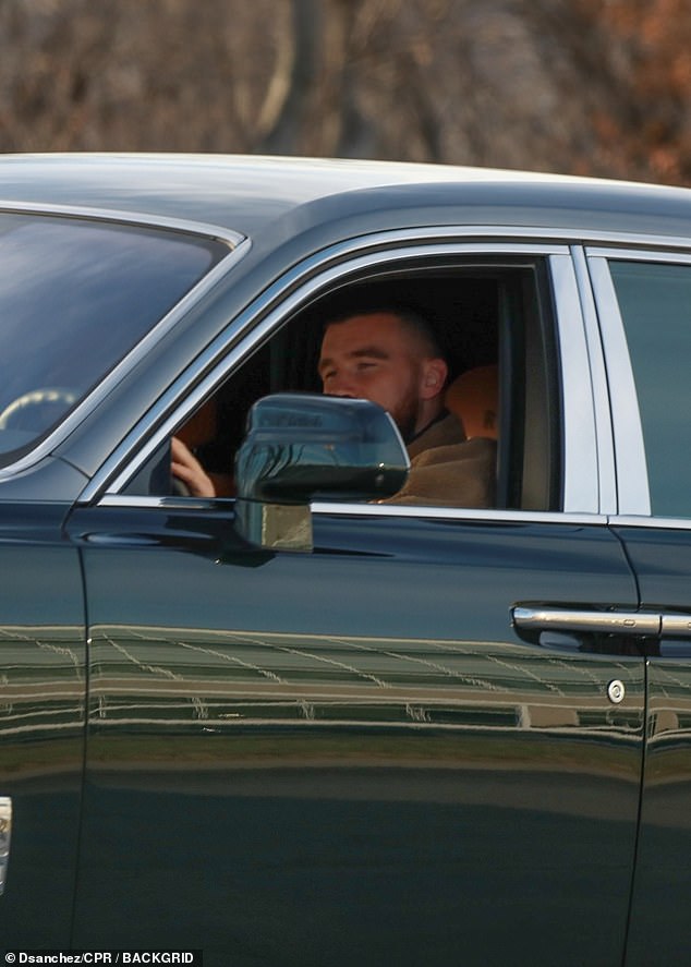 Kelce is seen behind the wheel of his Rolls-Royce on Wednesday after Swift left for London