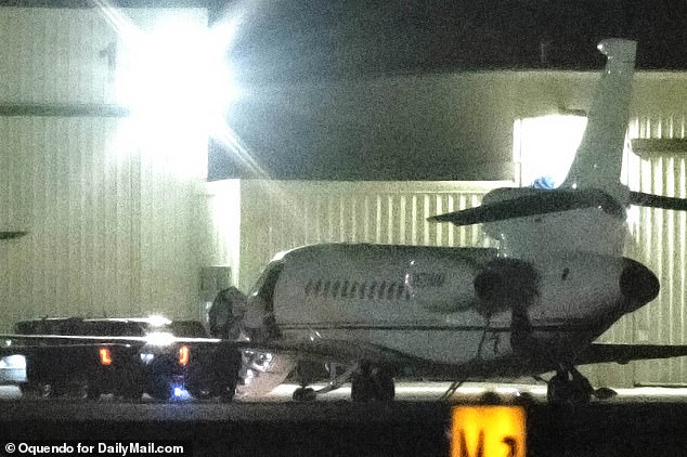 Swift can be seen boarding the plane on Wednesday evening, wearing a white top