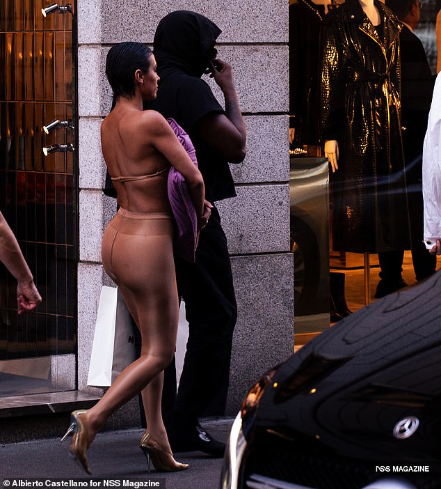 Kanye West's 'wife' Bianca Censori has been spotted on the street wearing that scandalous topless kissing outfit - despite an ongoing police investigation into the couple's 'lewd' behavior