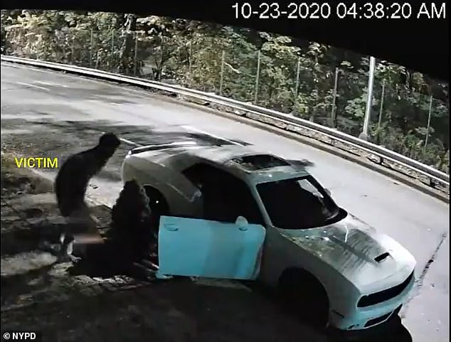 After dumping the woman's body, the man in the video jumps into his car and drives away