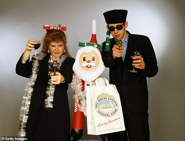 MacColl and MacGowan pose with toy guns and an inflatable Santa Claus in 1987 for their hit Fairytale of New York