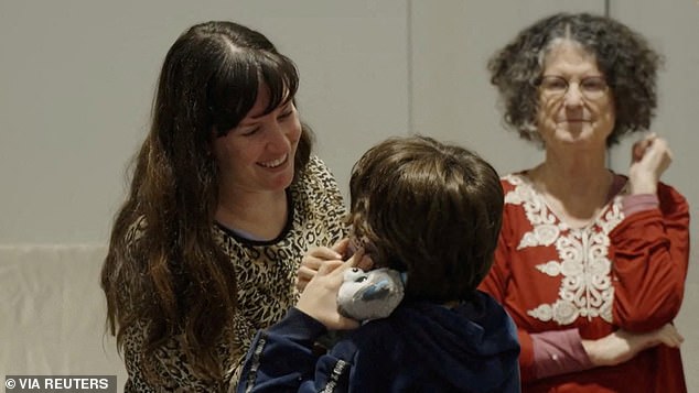 Shoshan Haran stands next to Adi Shoham, 38, and her son Nave Shoham, 8, after their arrival in Israel on November 25 after being taken hostage by Hamas