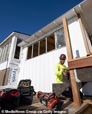 A worker builds a staircase at cottage #3 of the Crystal Cove Beach Cottages