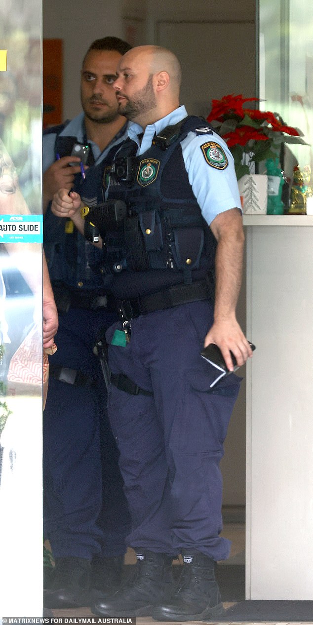 The Home Office has drawn up a list of serious offenders in immigration detention, ahead of the High Court ruling that freed at least 111 detainees.  Police are pictured at a motel where asylum seekers have been released