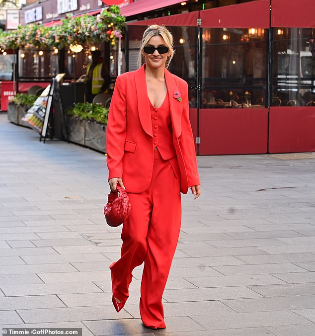 In love: Ashley Roberts, 42, had a loving look as she left the global radio studios on Monday in a glamorous red suit