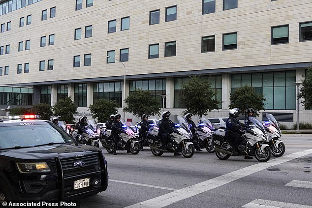 Austin Police Department officers prepare to ride in a procession leaving Dell Seton Medical Center in downtown Austin following the shooting of a police officer early Saturday