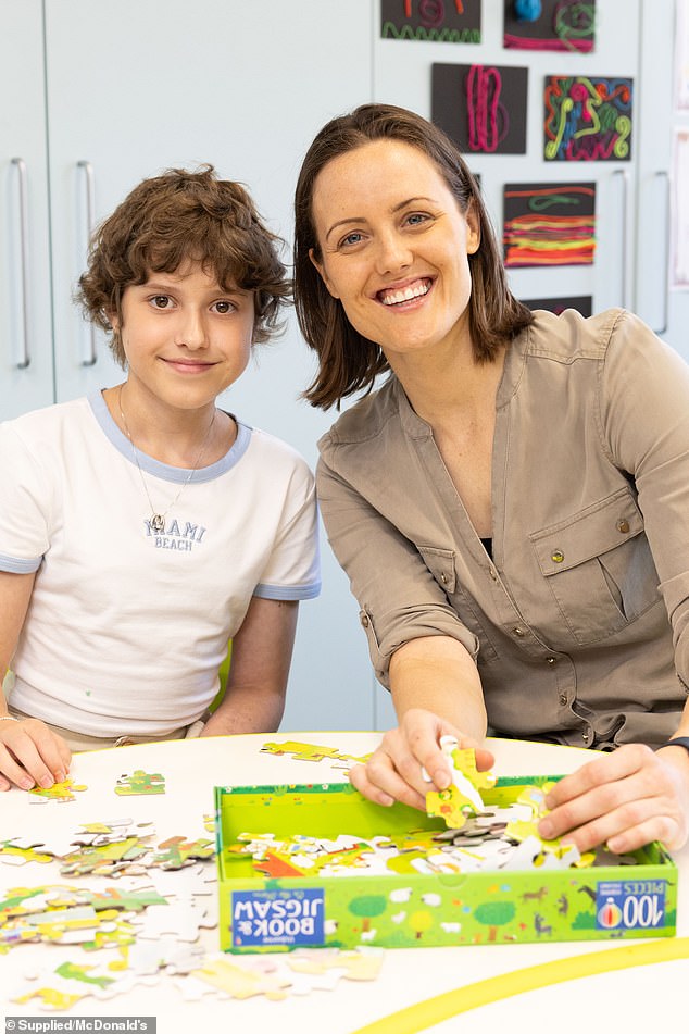 Australian Paralympic swimmer Ellie Cole, 31, (right) visited Sydney's Ronald McDonald House on Friday to meet a 10-year-old girl (left) who was being treated for sarcoma