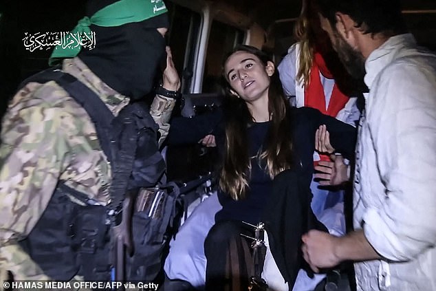 A Hamas fighter and Red Cross medics help recently released Israeli hostage Maya Regev into a Red Cross vehicle in the Gaza Strip