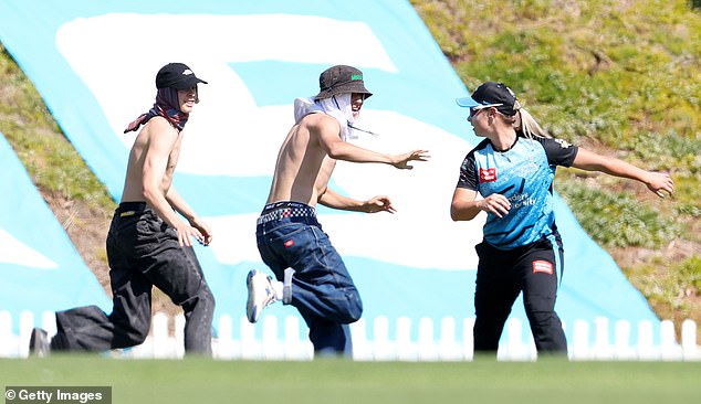 A women's cricket match was disrupted by two masked invaders on Wednesday