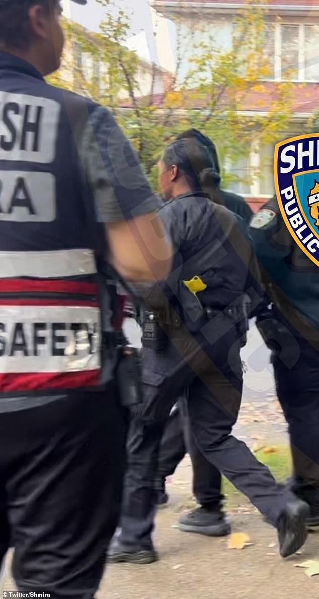 A still from the video of Melissa Ugur being led away by police after pepper spraying a volunteer security guard in Midwood, Brooklyn