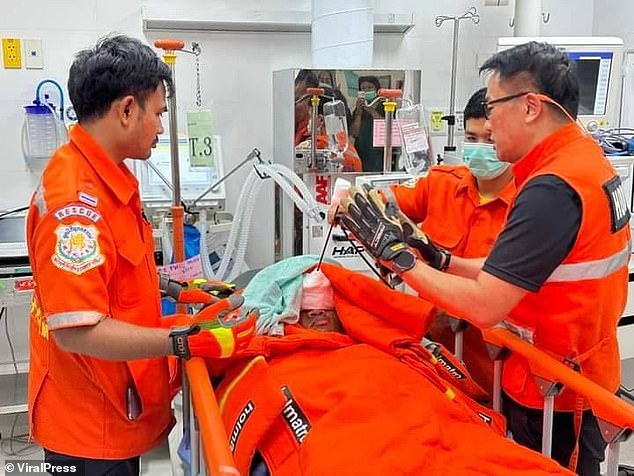 Chayathorn Thankrathok (pictured, center) was rushed to a nearby hospital by his friends after his horrific injury