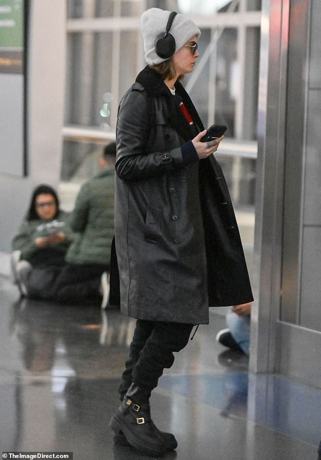 Staying comfortable: Delevingne also donned sweatpants and tucked their pants into leather combat boots