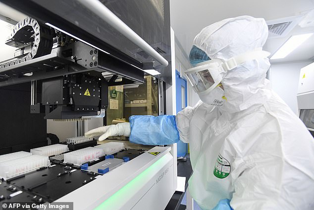 Congress moves closer to effectively banning US from doing business with China-based genomics company, lab pictured above, accused of stealing US DNA and exploiting Covid to collect genetic data