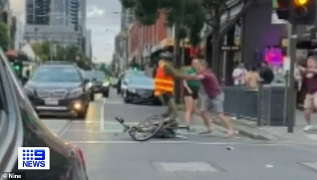 Mr Martin-Cohen tries to fend off a man who aggressively ran towards him in the middle of Melbourne's Chapel St on Sunday evening