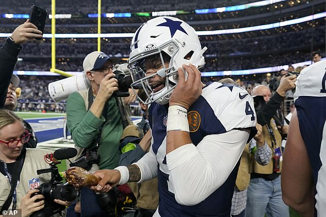 Dak Prescott enjoys a turkey leg after extending the Cowboys' lead to 38-10 vs.  Washington