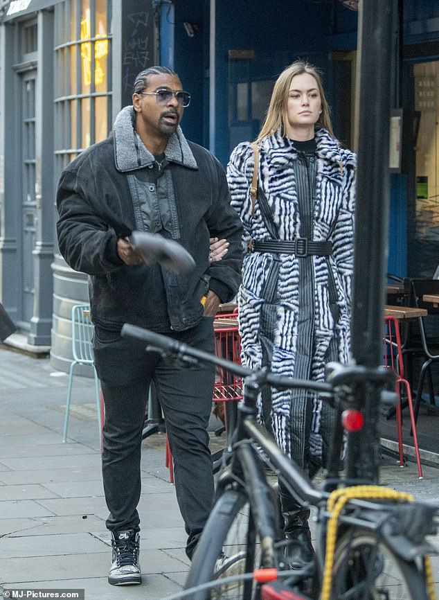 In love: David Haye, 41, and girlfriend Sian Osborne, 31, packed on the PDA as they enjoyed a romantic stroll in London's Soho on Wednesday