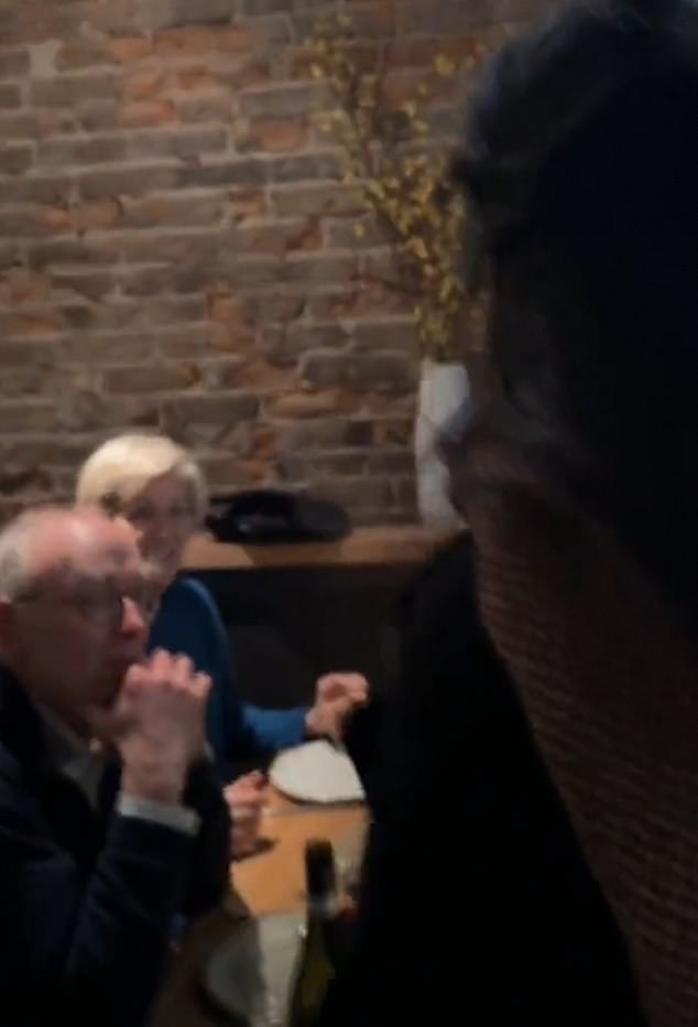 In the video, Senator Elizabeth Warren is seen having dinner with three others when she is interrupted