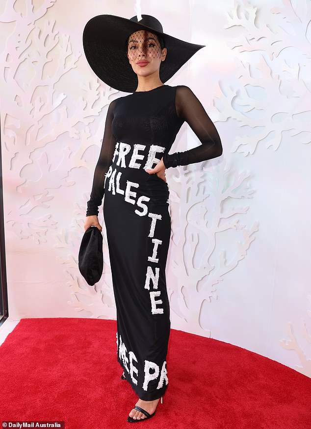 The Victoria Racing Club (VRC) has been criticized for allowing racegoer Mesisca Barrientos (pictured) to wear a dress covered in politically charged slogans relating to the Israel-Gaza conflict during Melbourne's Spring Racing Carnival