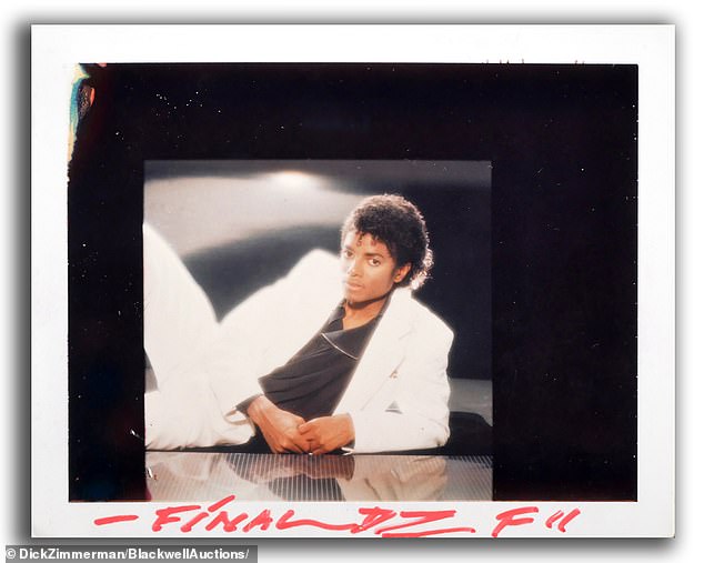 In the photo of Michael Jackson selected for the cover, he is lying on a counter, wearing a white jacket and pants and a black top.  A nearly identical Polaroid photo is included in the series of five test photos Zimmerman took for the shoot