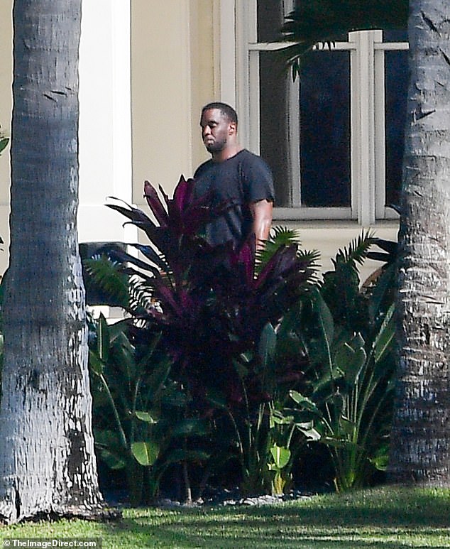 Wearing all-black clothing, Sean 'Diddy' Combs was seen looking pensively at his luxury Florida property on Friday