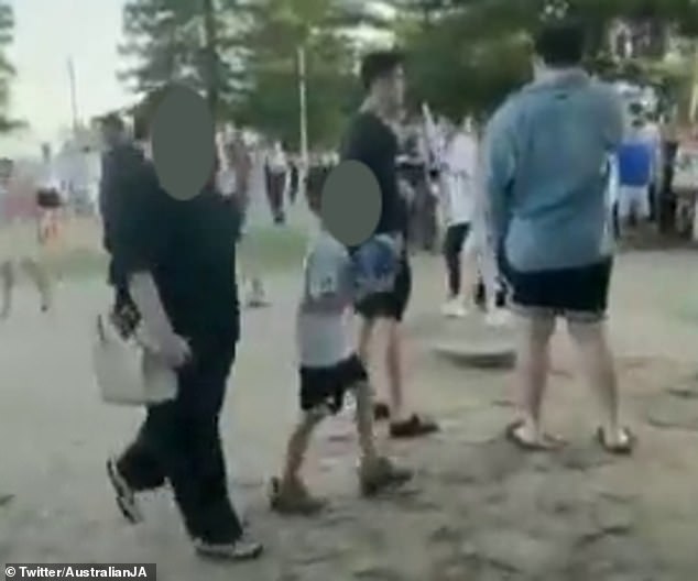 A woman and child (pictured) were caught on video shouting 'f*** the Jews' after an anti-Israel rally in Sydney