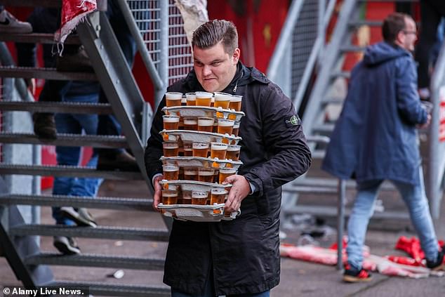 Dutch club FC Twente have revealed in their latest accounts that they make more money from selling beer than they do from players.  One of their fans is pictured with a stack of pints in the stands