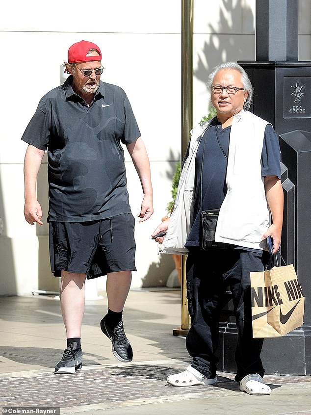 Matthew Perry had a live-in assistant and caregiver, 59-year-old Kenny Iwamasa (pictured together in August), who allegedly discovered him in his hot tub last month