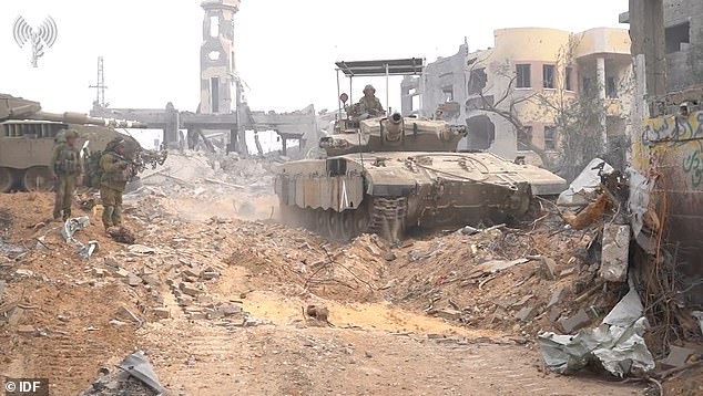 An Israeli tank is seen driving through Gaza on Tuesday during Israel's ground invasion