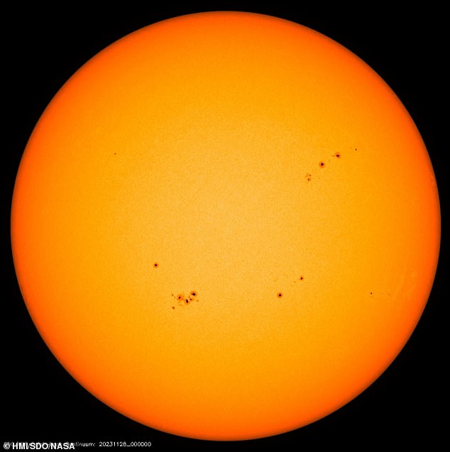 Researchers have discovered a new relationship between the sun's magnetic field and the sunspot cycle, which could help predict when the peak of solar activity will occur.  This image from the Solar Dynamics Observatory shows the Sun with multiple sunspots, which appear dark compared to their surroundings.