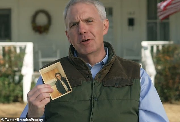 Mississippi Democratic governor hopeful Brandon Presley holds up a photo of his second cousin, Elvis Presley, in a video announcing his campaign.  If the polls are correct, he is within striking distance of defeating Republican Governor Tate Reeves