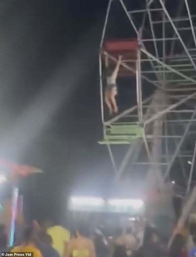 The young girl held on for dear life as the Ferris wheel continued to spin at the fairground in Rio Preto da Eva, Brazil